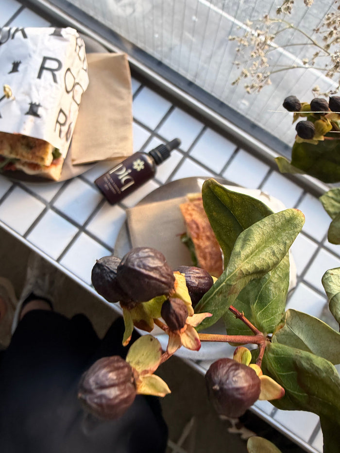 Overhead view of a café table with pastries, coffee and greenery